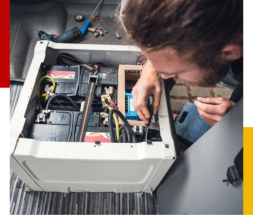 Man inspecting vehicle battery compartment