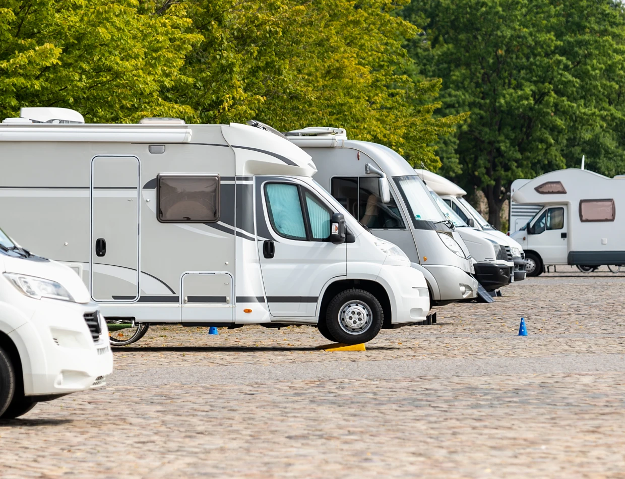 White RVs aligned in a parking lot